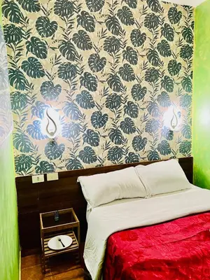 a bedroom with a bed and a wall with wallpaper at Magenta Roma house in Rome
