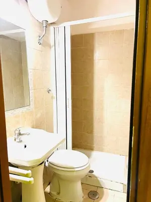 a bathroom with a toilet and a sink and a tub at Magenta Roma house in Rome