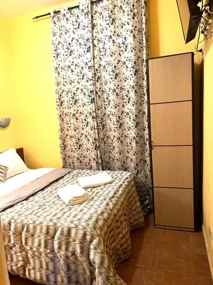 a bedroom with a bed and a curtain with towels on it at Magenta Roma house in Rome