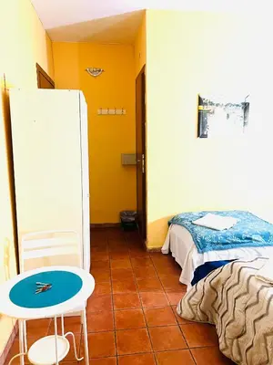 a room with a bed and a table and a table at Magenta Roma house in Rome