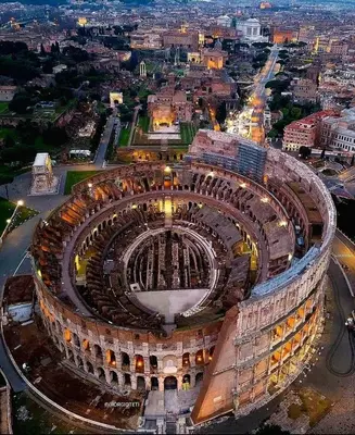 an aerial view of the colosseum at night at Magenta Roma house in Rome