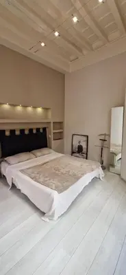 a bedroom with a large bed in a room at Savelli Apartment Old Town - near Navona Place in Rome