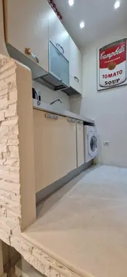 a kitchen with a sink and a washing machine at Savelli Apartment Old Town - near Navona Place in Rome