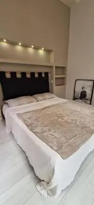 a bedroom with a large bed with a white blanket at Savelli Apartment Old Town - near Navona Place in Rome