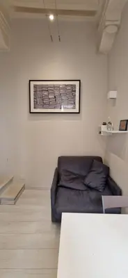 a living room with a couch and a picture on the wall at Savelli Apartment Old Town - near Navona Place in Rome