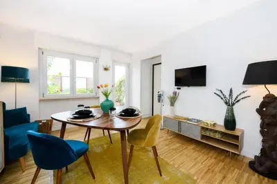 a living room with a table and chairs at Rooftop Porretta Città Giardino Check-in From 3 Pm To 10 Pm in Rome