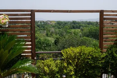 a view from the balcony of a house with trees at Rooftop Porretta Città Giardino Check-in From 3 Pm To 10 Pm in Rome