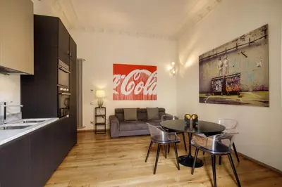 a living room with a table and a couch at Porta Castello Charme in Rome
