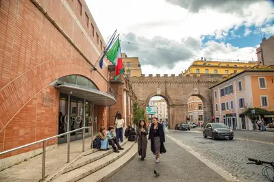 a group of people walking down a city street at Porta Castello Charme in Rome