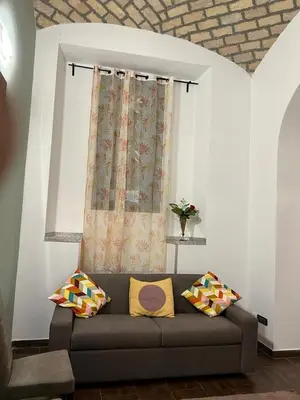 a living room with a couch and a window at la rosa di roma colosseo in Rome