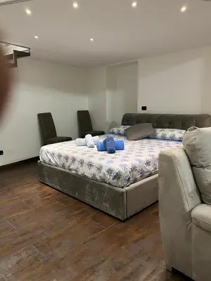 a bedroom with a large bed and a couch at la rosa di roma colosseo in Rome