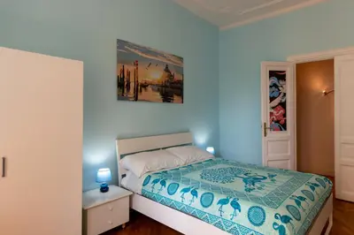 a bedroom with a bed and a painting on the wall at Green Window Roma in Rome