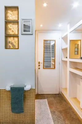 a bathroom with a white door and a green towel at Green Window Roma in Rome
