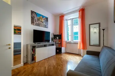 a living room with a couch and a tv at Green Window Roma in Rome