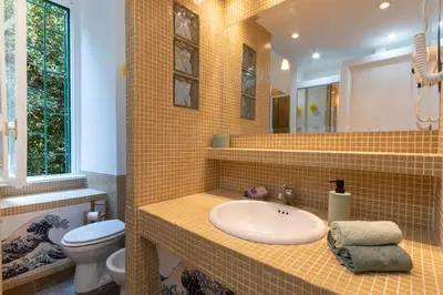 a bathroom with a sink and a toilet at Green Window Roma in Rome
