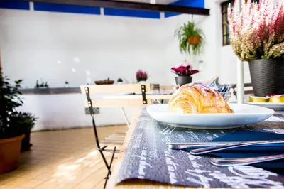 a pastry on a plate on a table at Casa Maplink in Rome