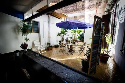 a patio with an umbrella and a table and chairs at Casa Maplink in Rome