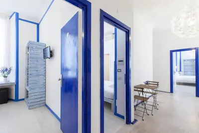 a room with blue doors and a table and a bed at Casa Maplink in Rome