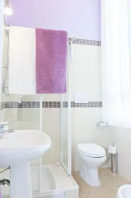 a white bathroom with a sink and a toilet at Casa Maplink in Rome