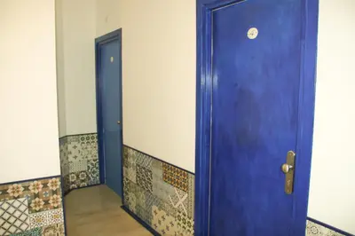 a blue door in a room with a hallway at Casa Maplink in Rome
