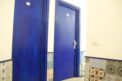 a blue door in a room with a wall at Casa Maplink in Rome
