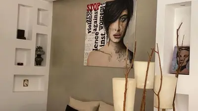a room with a picture of a woman on the wall at Karol Apartment Rome in Rome