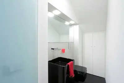 a bathroom with a sink and a red towel at Karol Apartment Rome in Rome