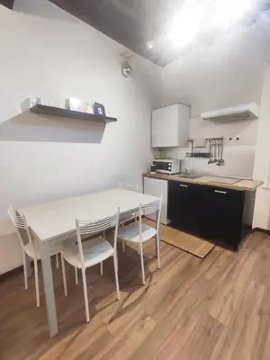 a kitchen with a table and chairs in a room at Chroma Italy - Chroma Apt Campo de' Fiori in Rome
