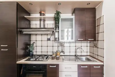 a kitchen with a sink and a stove top oven at The Best Rent - Three-bedroom apartment in Porta Maggiore area in Rome