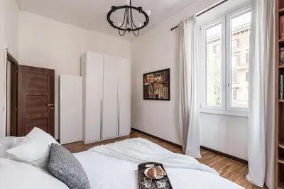 a white bedroom with a bed and a window at The Best Rent - Three-bedroom apartment in Porta Maggiore area in Rome