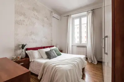 a bedroom with a bed and a window at The Best Rent - Three-bedroom apartment in Porta Maggiore area in Rome