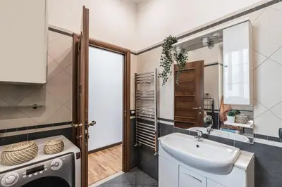 a bathroom with a sink and a washing machine at The Best Rent - Three-bedroom apartment in Porta Maggiore area in Rome
