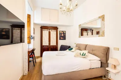 a bedroom with a bed and a couch at The Eclectic Loft Spagna in Rome