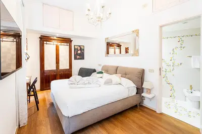 a couch with two pillows on it in a living room at The Eclectic Loft Spagna in Rome