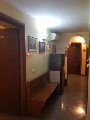 a hallway with a room with a refrigerator on the wall at B&B Rudy Center in Rome