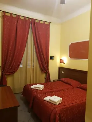a hotel room with two beds with towels on them at B&B Rudy Center in Rome