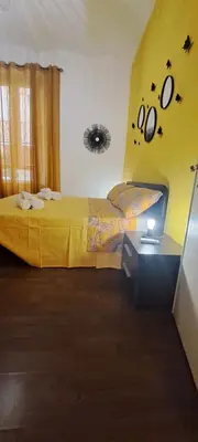 a bedroom with two beds and a yellow wall at Central Rome Suite in Rome