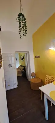 a room with a room with a table and a plant at Central Rome Suite in Rome
