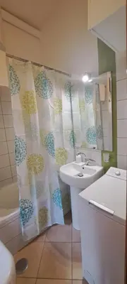 a bathroom with a sink and a shower curtain at Central Rome Suite in Rome