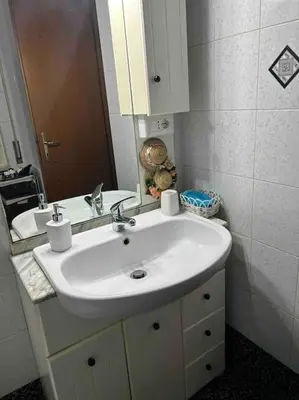 a bathroom with a white sink and a mirror at Pochi passi da San Pietro Metro A Cipro in Rome