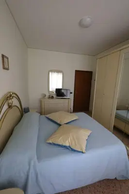 a bedroom with a large blue bed with two pillows at Pochi passi da San Pietro Metro A Cipro in Rome