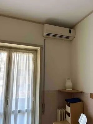 a room with a ceiling fan and a window at Pochi passi da San Pietro Metro A Cipro in Rome