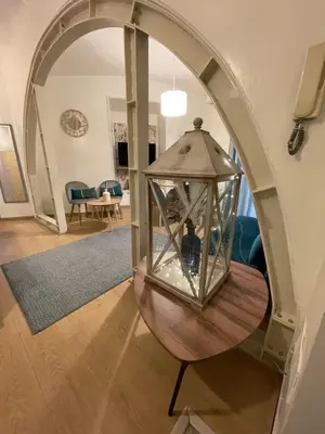 a glass lantern on a wooden table in a living room at Blue vatican house Rome in Rome