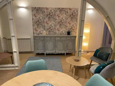 a living room with tables and chairs and a wall at Blue vatican house Rome in Rome