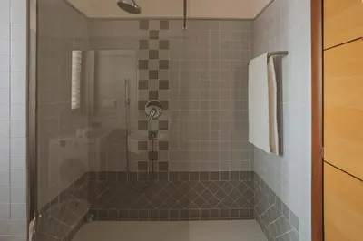 a bathroom with a shower with a glass door at EasyTopStay - Peaceful Retreat near San Pietro in Rome