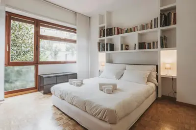 a bedroom with a large white bed with shelves at EasyTopStay - Peaceful Retreat near San Pietro in Rome