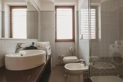 a white bathroom with a sink and a toilet at EasyTopStay - Peaceful Retreat near San Pietro in Rome
