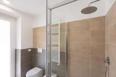 a bathroom with a shower and a toilet at Colosseo Modern by Rental in Rome in Rome
