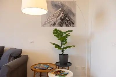 a living room with a potted plant on a table at Colosseo Modern by Rental in Rome in Rome
