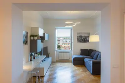 a living room with a blue couch and a table at Colosseo Modern by Rental in Rome in Rome